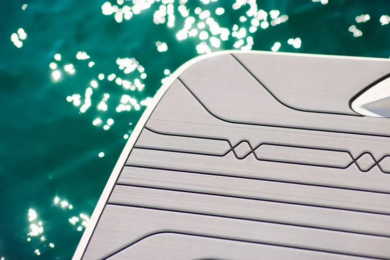 Slide: The Image of Close-up of 2024 Sea Ray 210SPX boat deck with sparkling water background. - 23