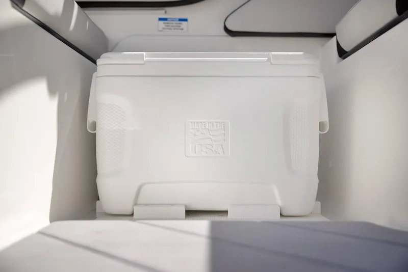 Slide: The Image of White cooler in 2024 Sea Ray 210SPX boat interior, labeled "Made in the USA." - 24