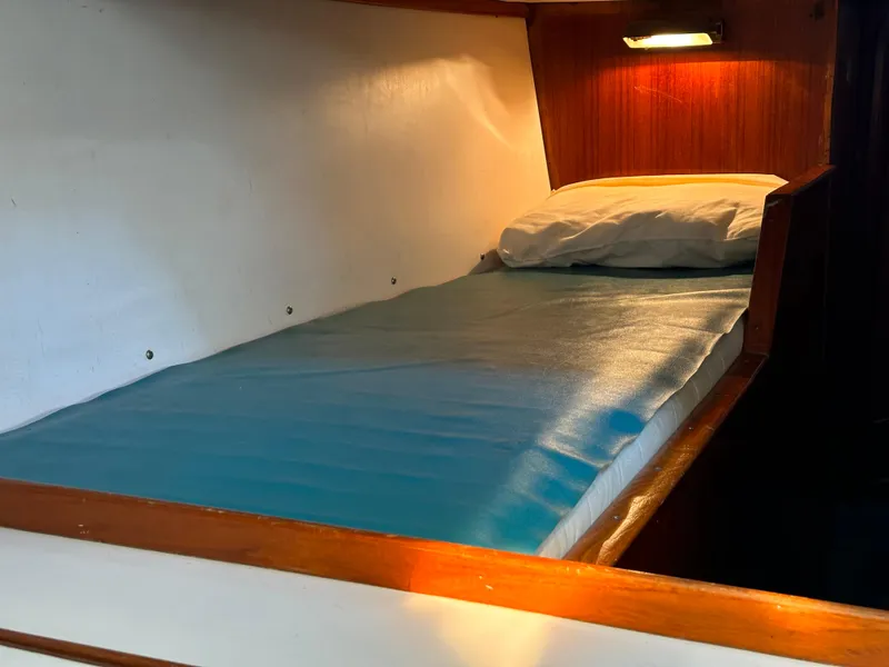 Slide: The Image of Cozy cabin bed in 1978 Rival 41C sailboat with soft lighting. - 11