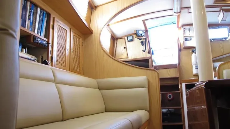 Slide: The Image of Interior of 1978 Rival 41C yacht with beige seating and wooden cabinetry. - 15