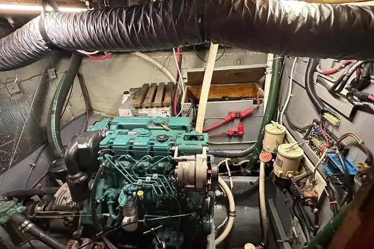 Slide: The Image of Engine room of a 1978 Rival 41C boat, featuring a well-maintained marine engine. - 21