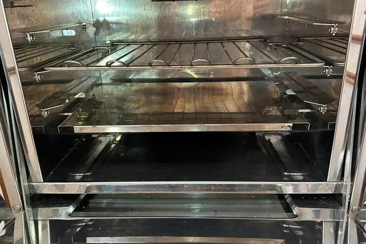 Slide: The Image of Vintage 1978 Rival 41C oven interior with metal racks and reflective surfaces. - 27