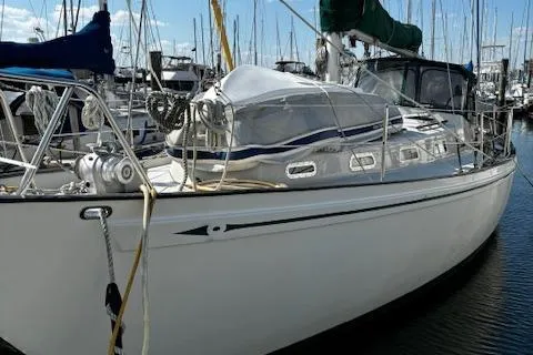 Slide: The Image of 1978 Rival 41C sailboat docked in marina, featuring sleek design and classic lines. - 28