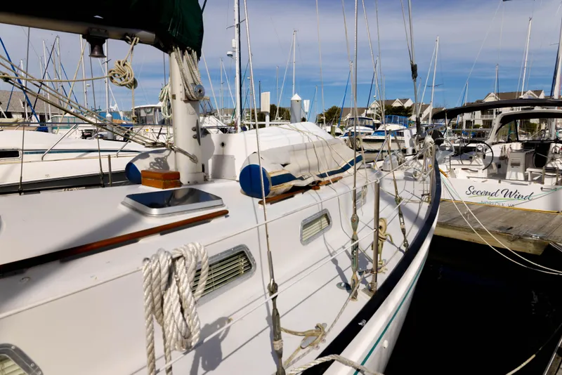 Slide: The Image of 1978 Rival 41C sailboat docked at marina, surrounded by other boats. - 29