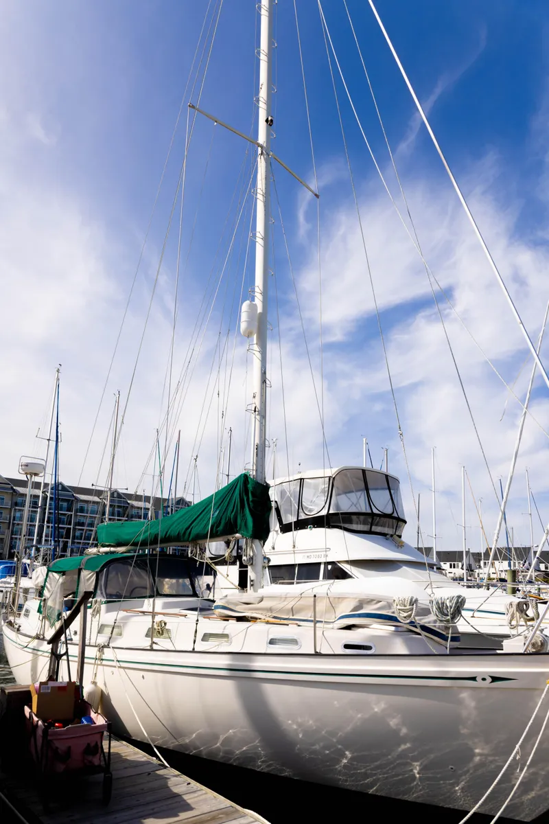 Slide: The Image of Sailboat docked at marina, Rival 41C, 1978 model, under clear blue sky. - 30