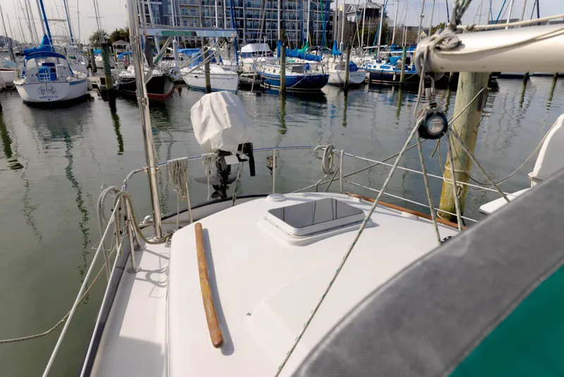 Slide: The Image of 1978 Rival 41C sailboat docked in a marina with other boats. - 33