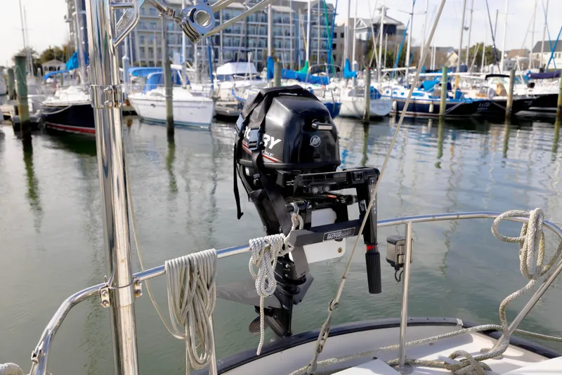 Slide: The Image of Outboard motor on a 1978 Rival 41C sailboat docked at a marina. - 34