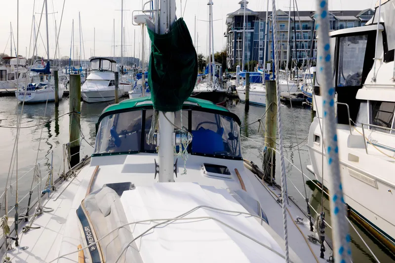 Slide: The Image of Sailboat docked in marina, Rival 41C, 1978 model, surrounded by other boats. - 37