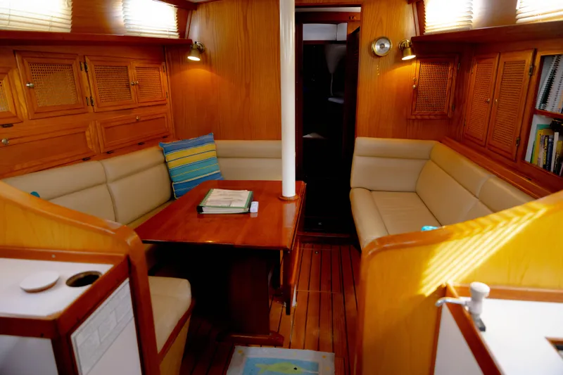Slide: The Image of 1978 Rival 41C yacht interior with wooden finish and cozy seating area. - 47