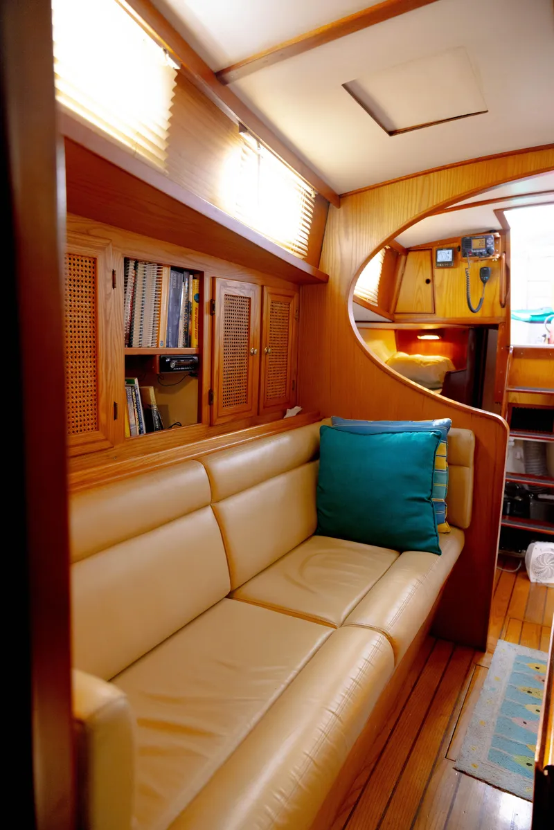 Slide: The Image of Cozy interior of 1978 Rival 41C yacht with beige seating and wooden accents. - 49