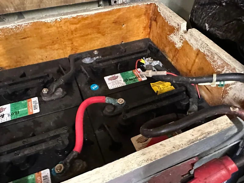 Slide: The Image of Batteries in a wooden compartment of a 1978 Rival 41C boat. - 7