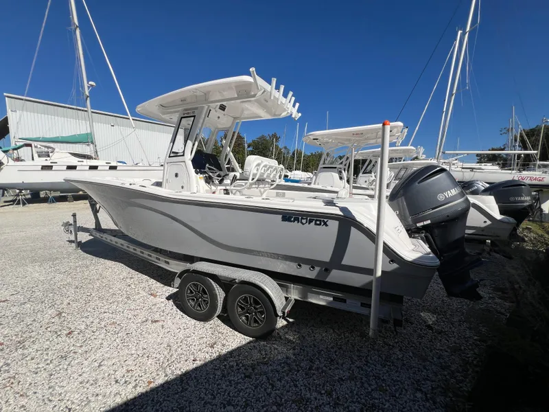 Slide: The Image of 2025 Sea Fox 248 Commander boat on trailer, parked outdoors. - 2
