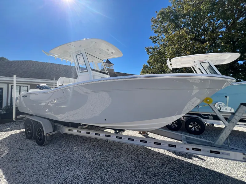 Slide: The Image of 2025 Sea Fox 248 Commander boat on trailer under clear blue sky. - 4