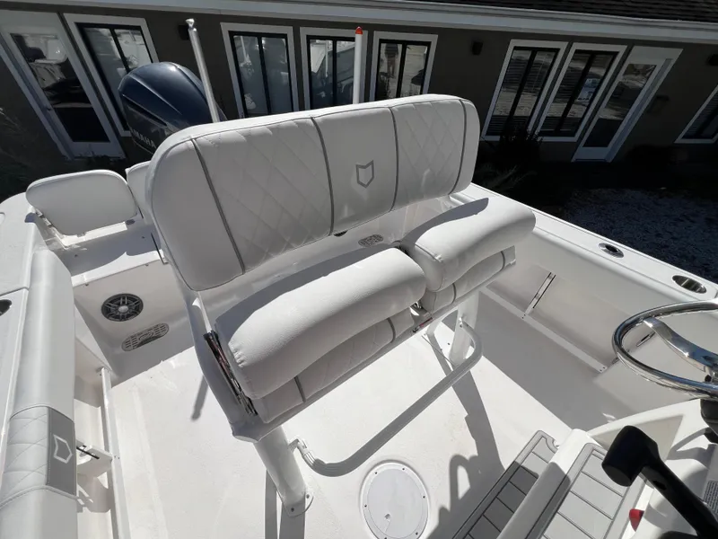 Slide: The Image of 2025 Sea Fox 248 Commander boat interior with cushioned seating and steering wheel. - 9