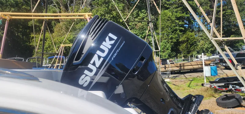 Slide: The Image of Suzuki outboard motor on 2025 Sea Pro 242 DLX boat, outdoor setting. - 6