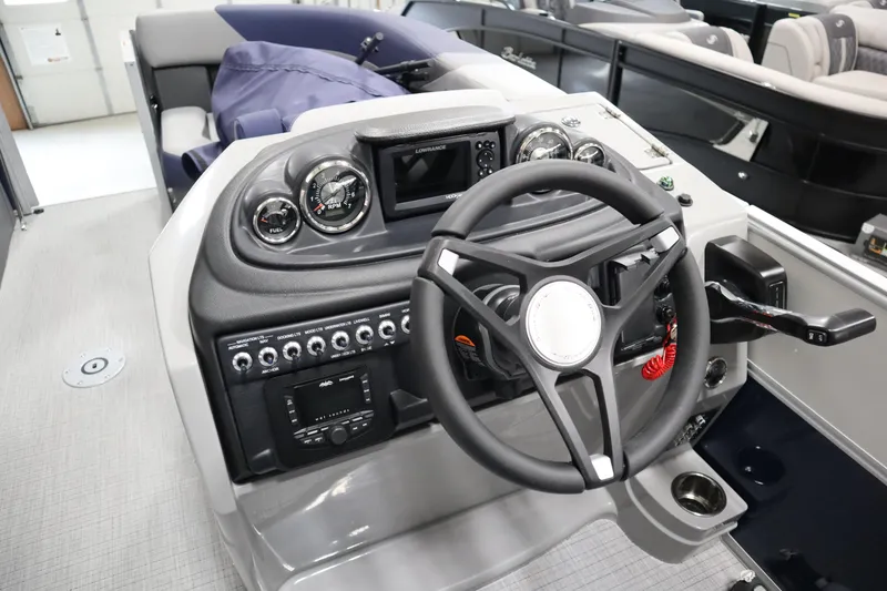 Slide: The Image of 2025 South Bay 222E boat dashboard with steering wheel and control panel. - 10