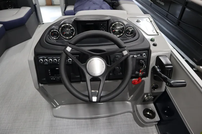 Slide: The Image of Steering console of 2025 South Bay 222E boat with modern controls and gauges. - 11