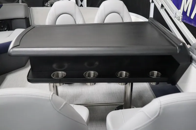 Slide: The Image of Luxury seating area with table and cup holders on 2025 South Bay 222E boat. - 19