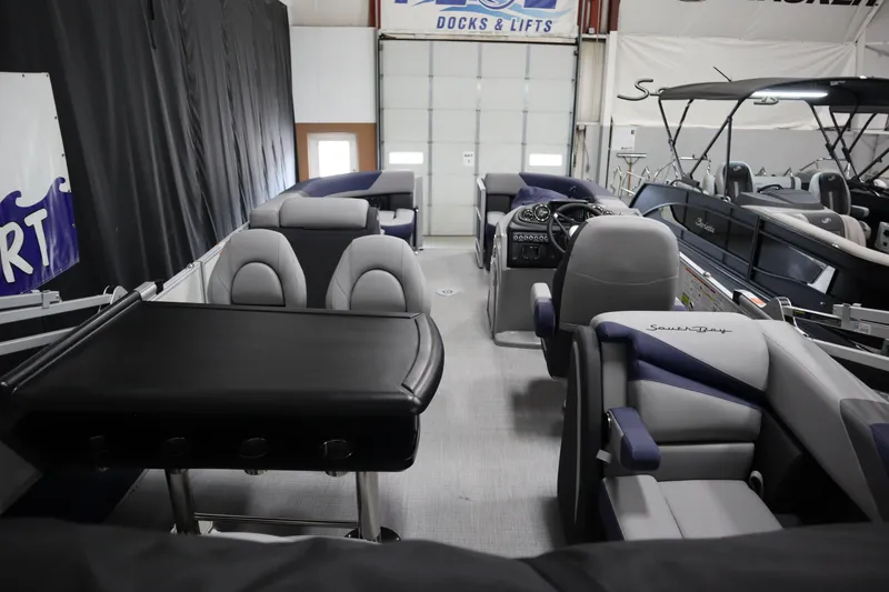 Slide: The Image of 2025 South Bay 222E pontoon boat interior with seating and steering console. - 21