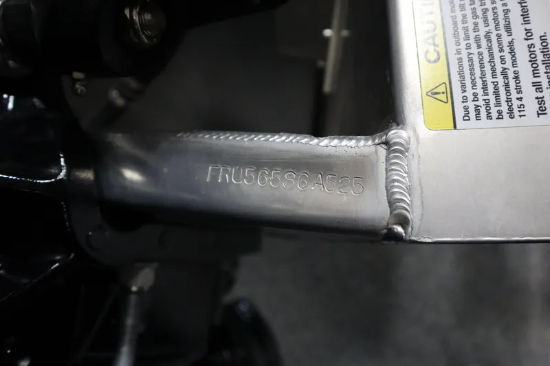 Slide: The Image of Close-up of a 2025 South Bay 222E metal component with serial number and caution label. - 22