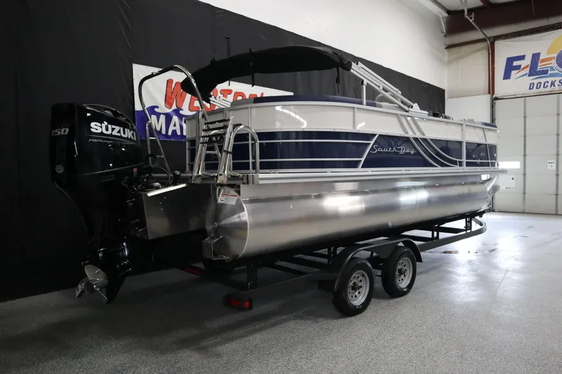 Slide: The Image of 2025 South Bay 222E pontoon boat with Suzuki engine on trailer in showroom. - 3