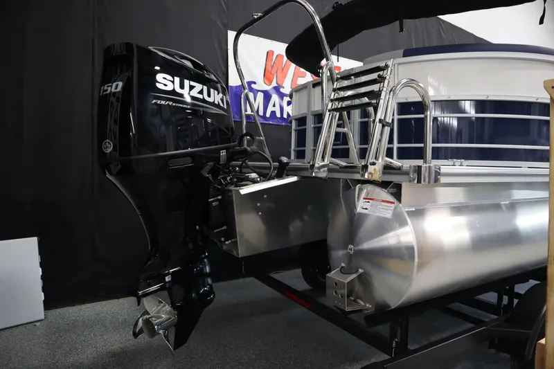 Slide: The Image of 2025 South Bay 222E pontoon boat with Suzuki 150 outboard motor, displayed indoors. - 4