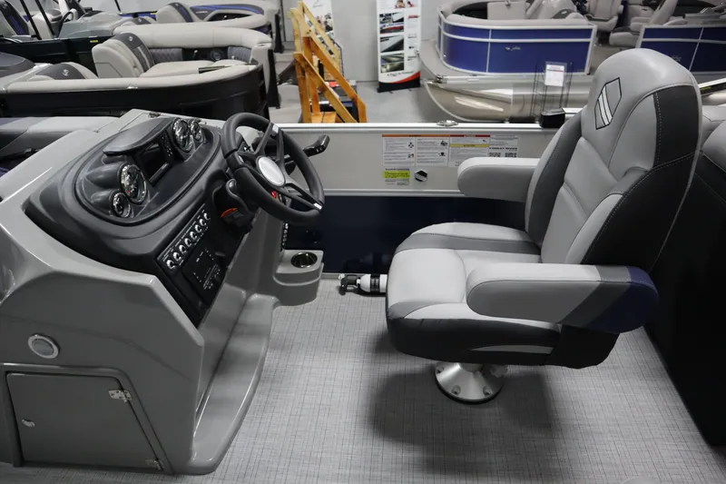 Slide: The Image of Captain's seat and helm of 2025 South Bay 222E pontoon boat, featuring modern controls and design. - 8