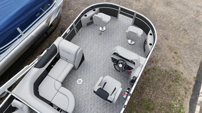 Slide: The Image of 2025 South Bay 220 F pontoon boat interior with seating and steering console. - 10