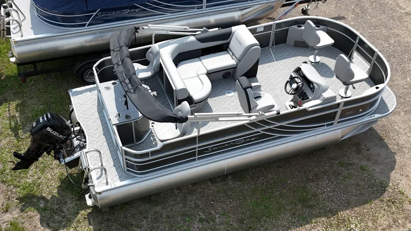 Slide: The Image of 2025 South Bay 220 F pontoon boat with seating and Suzuki outboard motor. - 2