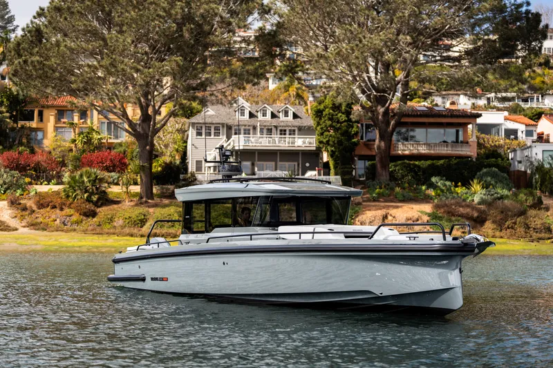 Slide: The Image of 2025 BRABUS 1000 Cross Cabin Signature Edition yacht on serene water near luxury homes. - 11