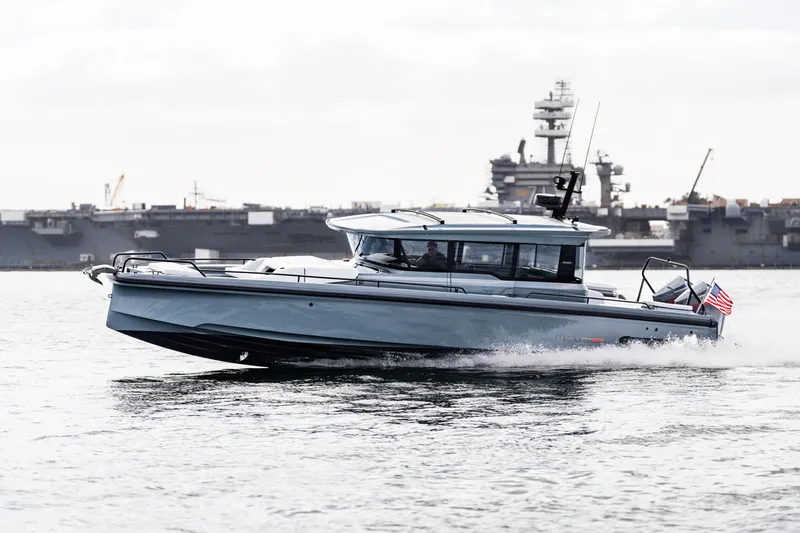 Slide: The Image of 2025 BRABUS 1000 Cross Cabin Signature Edition cruising on water, with ships in the background. - 4