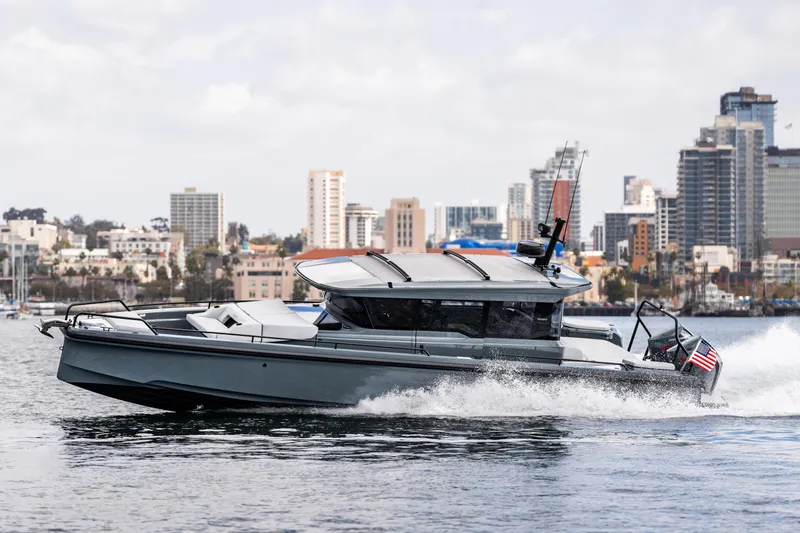 Slide: The Image of 2025 BRABUS 1000 Cross Cabin Signature Edition yacht cruising near city skyline. - 5