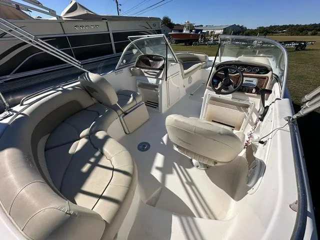 Slide: The Image of 2008 NauticStar 205DC Sport Deck boat interior with beige seating and steering console. - 3