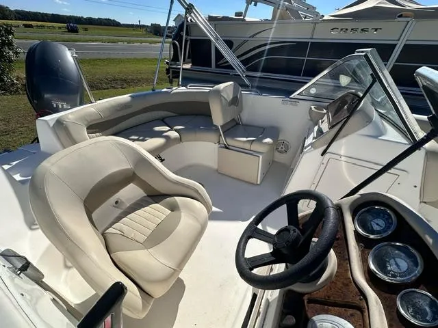 Slide: The Image of 2008 NauticStar 205DC Sport Deck boat interior with seating and steering wheel. - 4