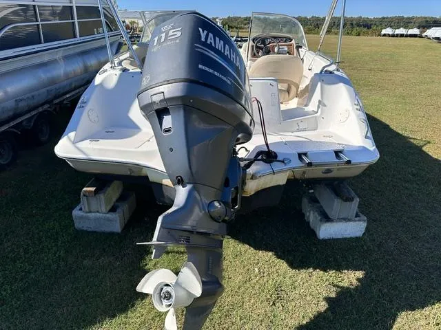 Slide: The Image of 2008 NauticStar 205DC Sport Deck with Yamaha 115 engine on grass. - 6