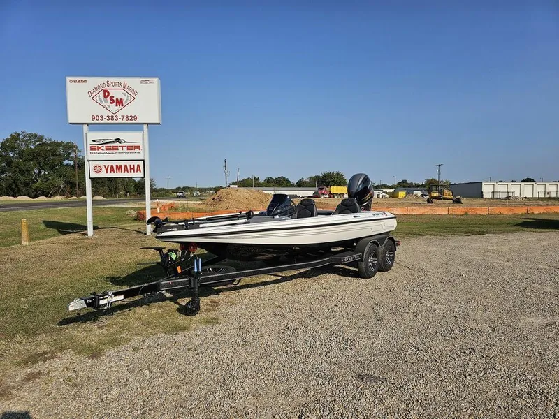 The Image of 2025 Skeeter ZX150 boat on trailer at dealership, sunny day, Yamaha sign visible. - 1
