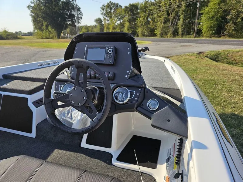 Slide: The Image of 2025 Skeeter ZX150 boat dashboard with steering wheel and navigation system. - 10