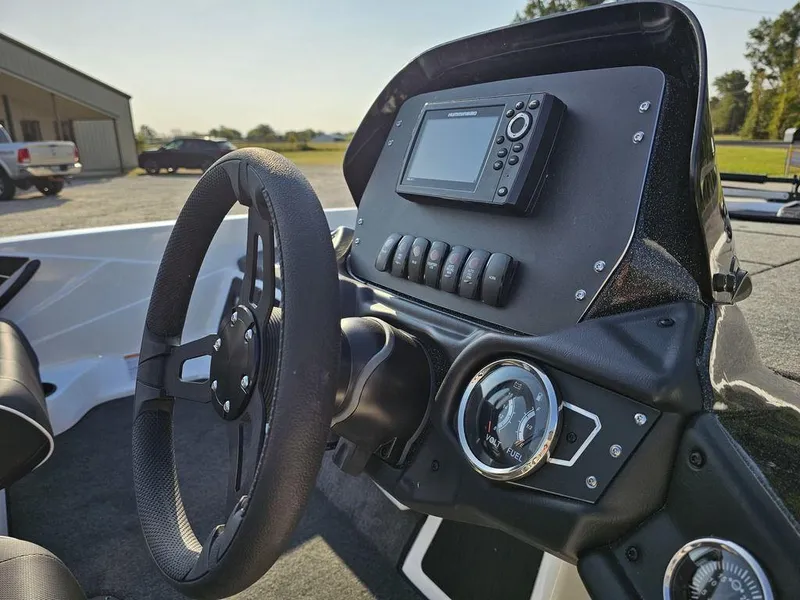 Slide: The Image of 2025 Skeeter ZX150 boat dashboard with steering wheel and electronic controls. - 11