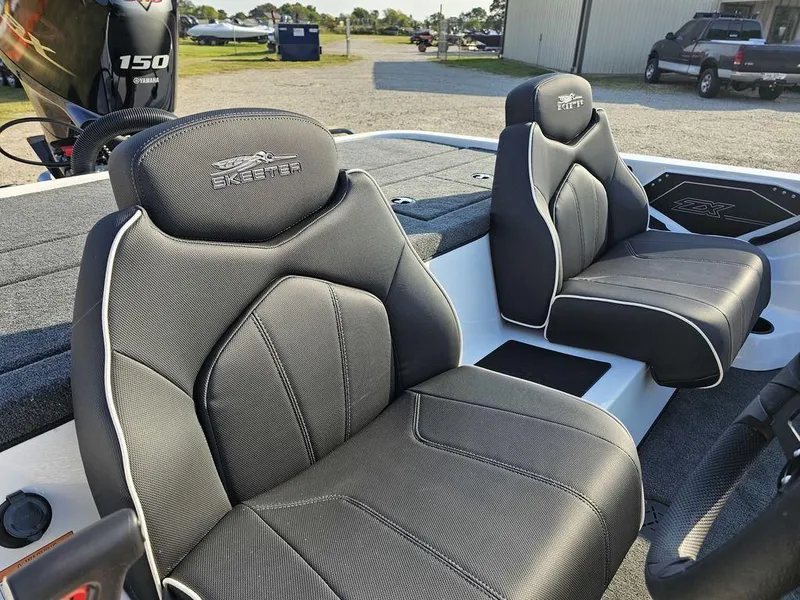 Slide: The Image of 2025 Skeeter ZX150 boat interior with sleek black seats and modern design. - 12
