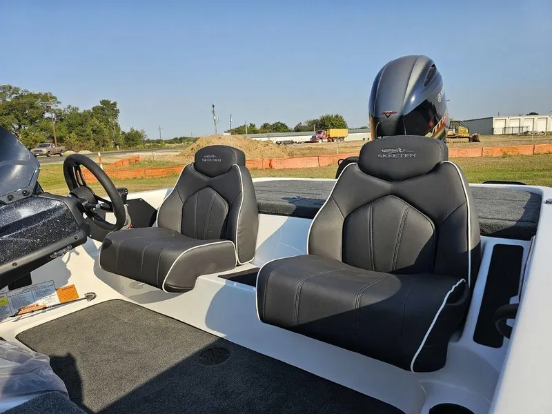 Slide: The Image of 2025 Skeeter ZX150 boat interior with black seats and steering wheel. - 5