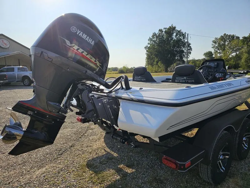 Slide: The Image of 2025 Skeeter ZX150 boat with Yamaha outboard motor, parked outdoors on a sunny day. - 9