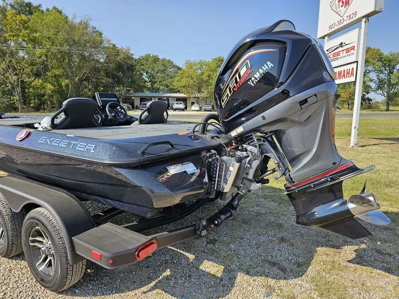 Slide: The Image of 2025 Skeeter ZXR19 boat with Yamaha engine on a trailer, parked outdoors. - 7
