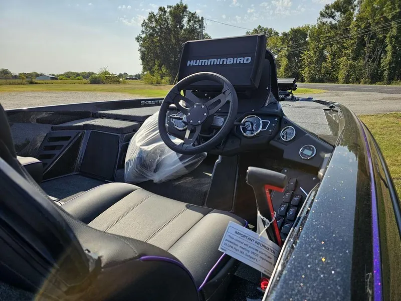 Slide: The Image of 2025 Skeeter ZXR19 boat interior with steering wheel and Humminbird electronics. - 9