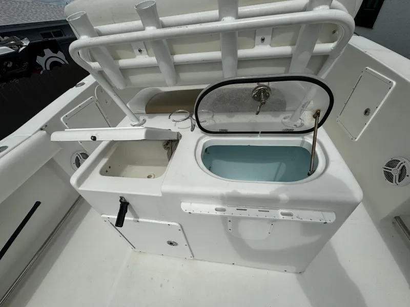 Slide: The Image of 2011 Sea Hunt Gamefish 29 boat with open livewell and storage compartments. - 14