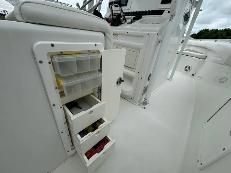 Slide: The Image of 2011 Sea Hunt Gamefish 29 boat with open storage compartments. - 17
