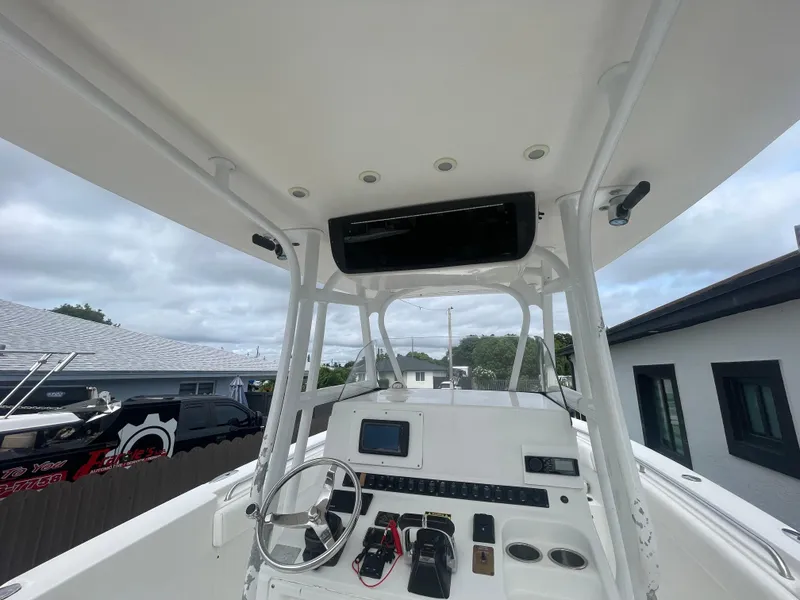 Slide: The Image of 2011 Sea Hunt Gamefish 29 boat console with steering wheel and electronics. - 18
