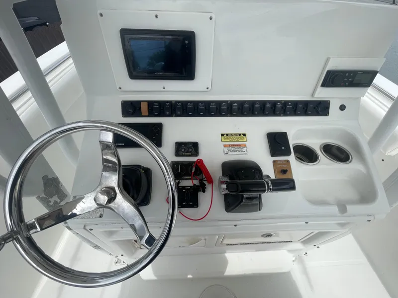 Slide: The Image of 2011 Sea Hunt Gamefish 29 helm with steering wheel and control panel. - 19