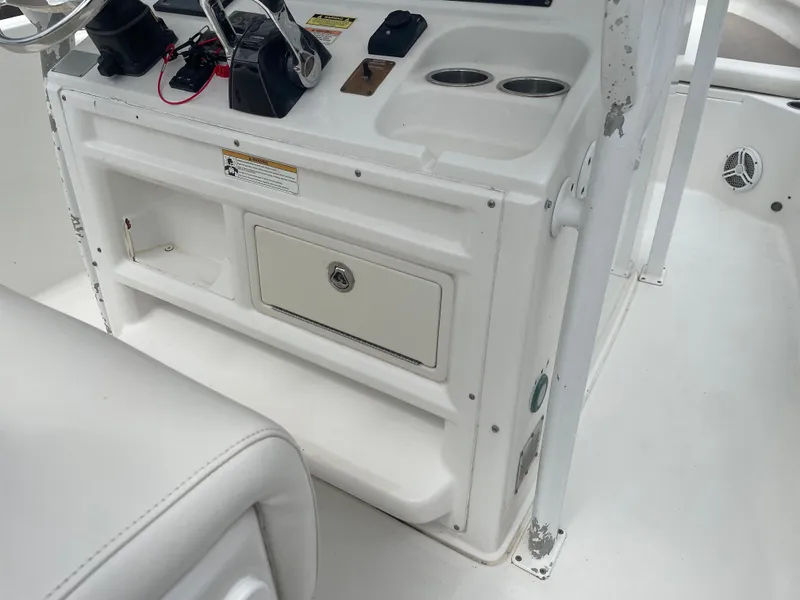 Slide: The Image of 2011 Sea Hunt Gamefish 29 boat console with storage and cup holders. - 26