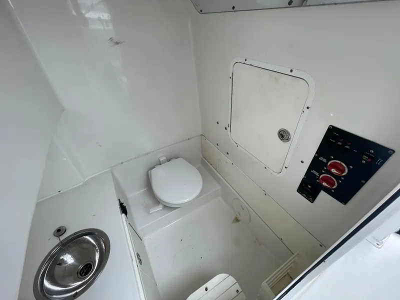 Slide: The Image of 2011 Sea Hunt Gamefish 29 boat interior with toilet and sink. - 28
