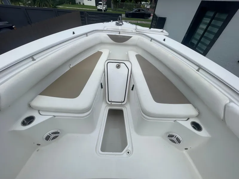 Slide: The Image of 2011 Sea Hunt Gamefish 29 boat interior with cushioned seating and storage. - 32